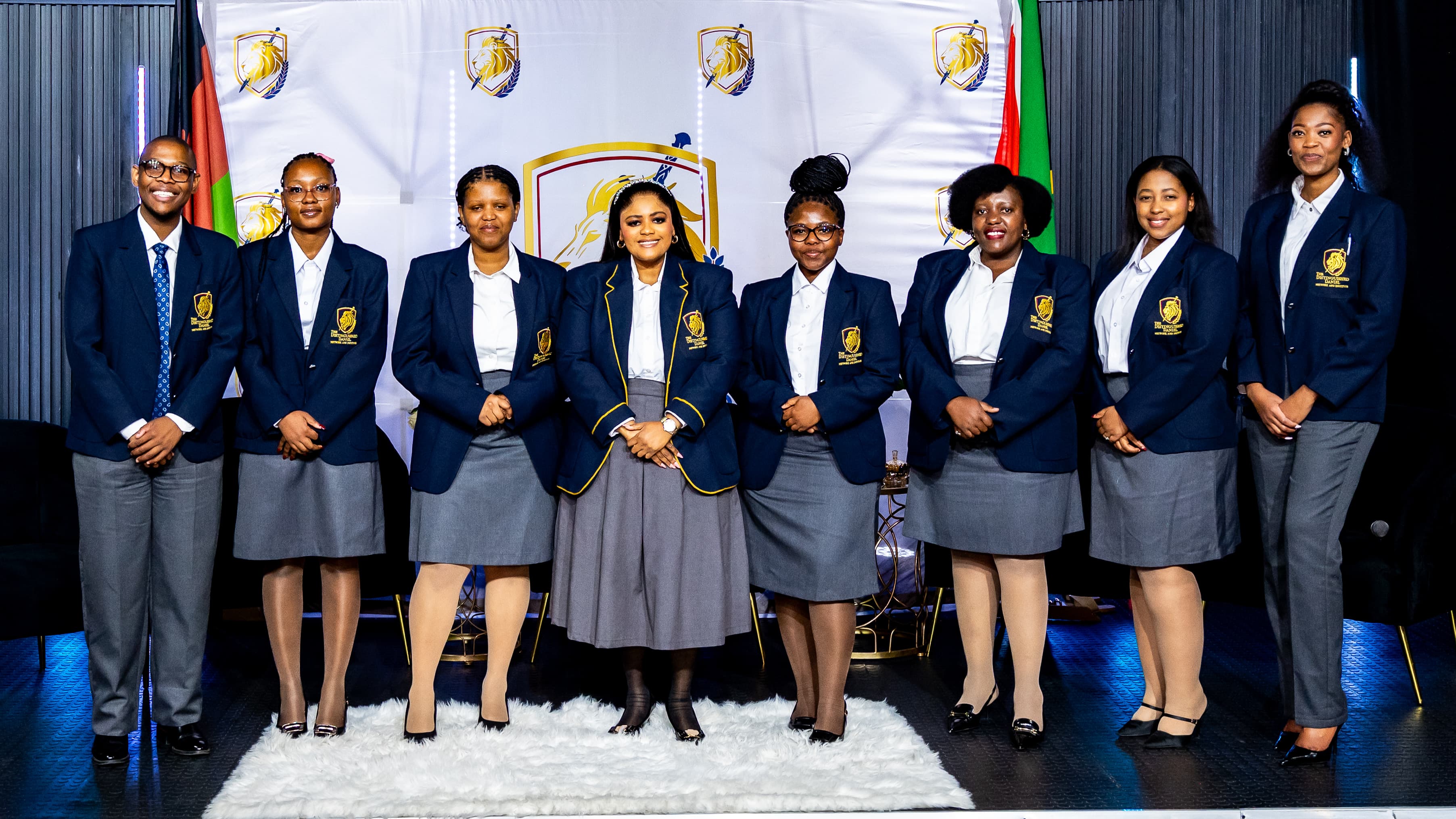 The full committee posed together in front of the institute crest